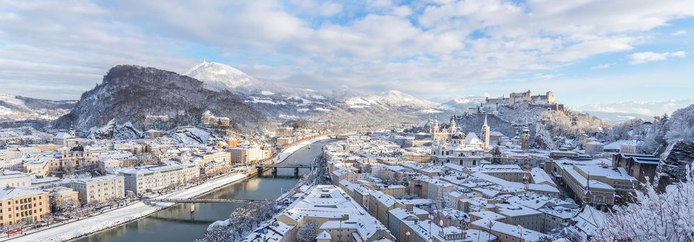 Panorama of Salzburg in winter: Snowy historical center, sunshine