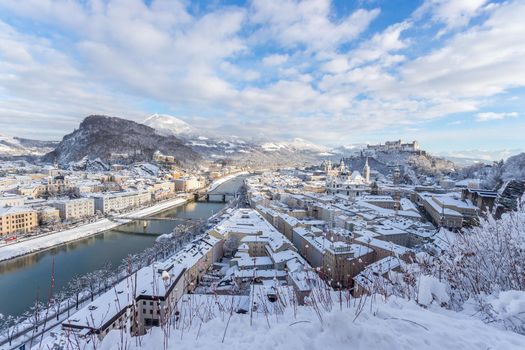 Panorama of Salzburg in winter: Snowy historical center, sunshine