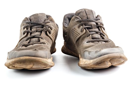 a pair of weared dirty sneakers isolated on white background, edge-to-edge sharpness, frontal vew