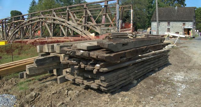 An Old Timber Frame Lumber Being Carefully Laid and Stored for Restoration