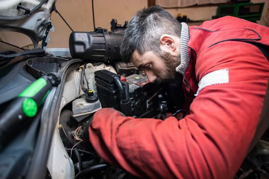 Mechanic working on the engine in the workshop