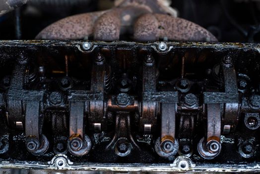 Dirty Valves and engine camshaft inside a broken engine