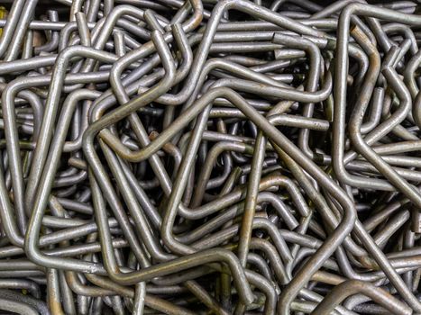 full frame abstract industrial background of bent steel rods.