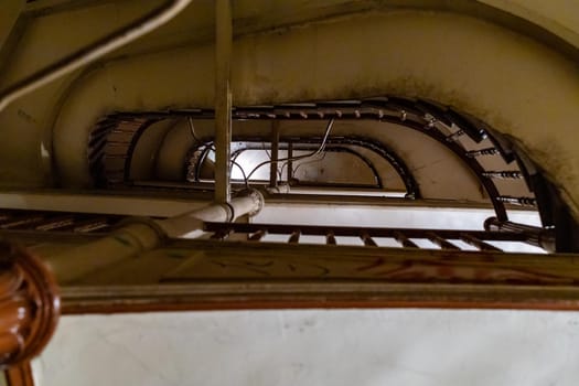 Upward view to old spiral staircase in old tenement house