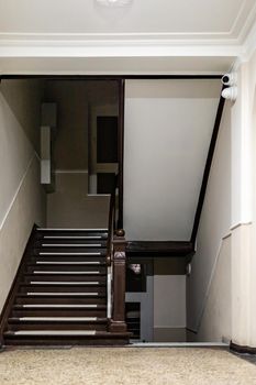 Dark staircase at afternoon in renovated tenement house