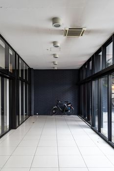 Long black and white corridor with bike standing at the end