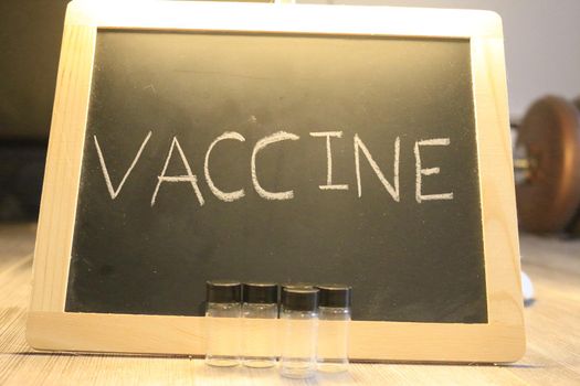 vaccine themed images with the word vaccine on a blackboard. High quality photo