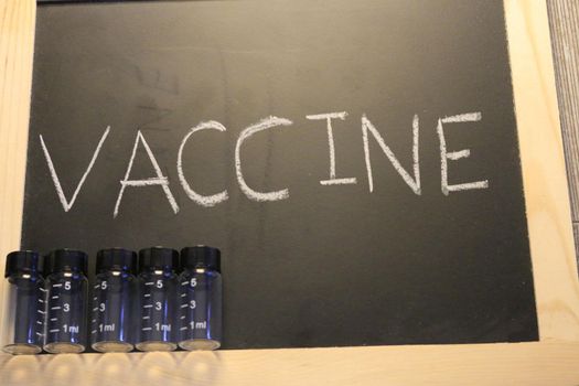 vaccine themed images with the word vaccine on a blackboard. High quality photo