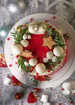 Christmas or New Year decorated cake with cream cheese frosting and cranberries