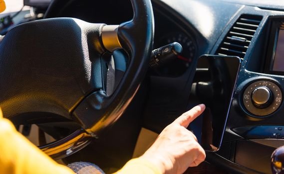 Asian woman inside a car and using touch screen on mobile smartphone blank screen while driving the car in the morning on highway she find navigation location to go Transportation and vehicle concept