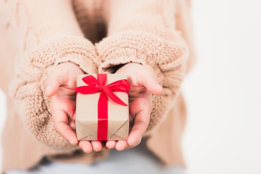 Valentine's Day. Woman beauty hands holding small gift package box present wrapped paper with ribbon isolated on white background, Birthday, New year, Christmas, holiday background concept