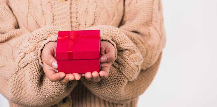 Valentine's Day. Woman beauty hands holding small gift package box present wrapped paper with ribbon isolated on white background, Birthday, New year, Christmas, holiday background concept