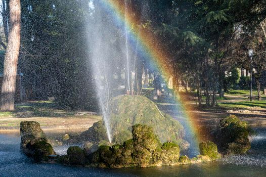 fountain with rainbow at the park in the center of terni