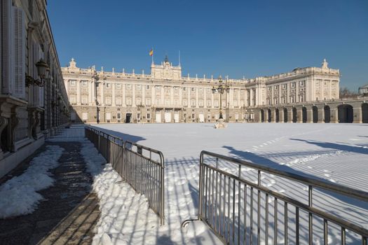 Madrid, Spain - January 17, 2021: Details of the Royal Palace, with its main esplanade, still covered with snow, without being removed, for days, after the polar storm Filomena.