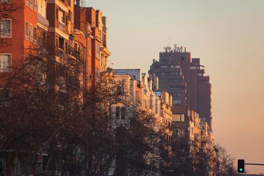 Madrid, Spain - January 17, 2021: General view of the rooftops of Menedez Pelayo avenue with the Torre del Retiro in the background, on a cold sunset after the polar storm Filomena.