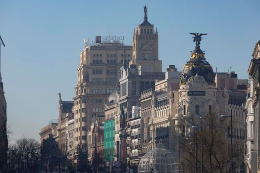 Madrid, Spain - January 17, 2021: General view of Alcala and Gran Via streets with the Metropolis building, in a cold day after Filomena.
