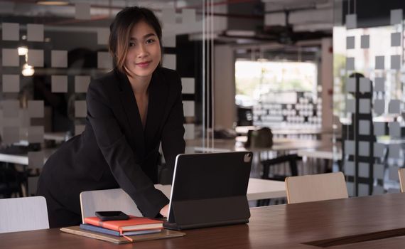 Portrait Of Attractive Asian Businesswoman Working On tablet for marketing plan, business concept.