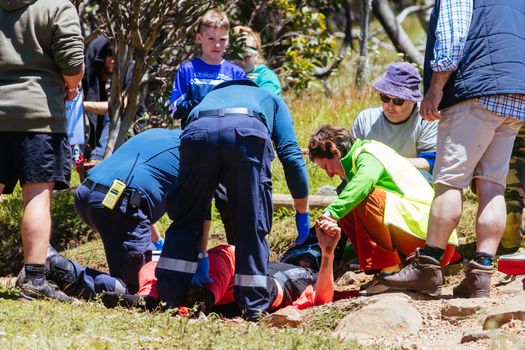 MT BULLER, AUSTRALIA - JANUARY 16, 2021: Liam Eaton is attended to after a crash during the finals for the Victorian Downhill Mountain Bike Series at Mt Buller