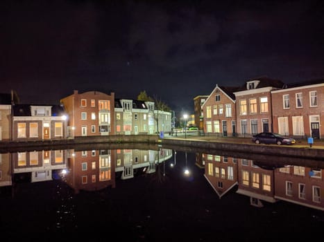 Housing along the canal at night in Sneek, Friesland, The Netherlands