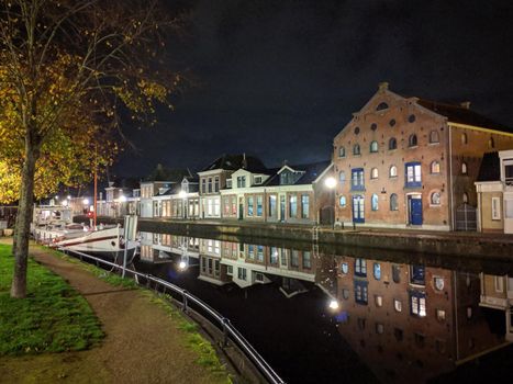 Housing along the canal at night in Sneek, Friesland, The Netherlands