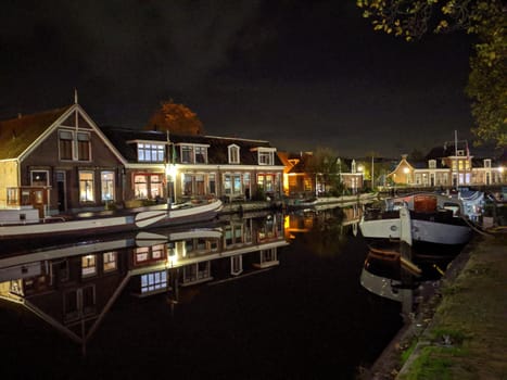 Housing along the canal at night in Sneek, Friesland, The Netherlands