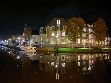 Housing along the canal at night in Sneek, Friesland, The Netherlands