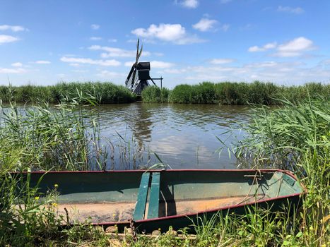 Windmill and a boat in Friesland The Netherlands