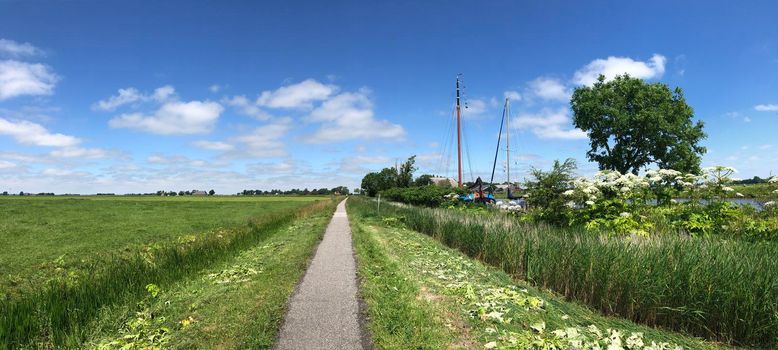 Bicycle path through Friesland in The Netherlands
