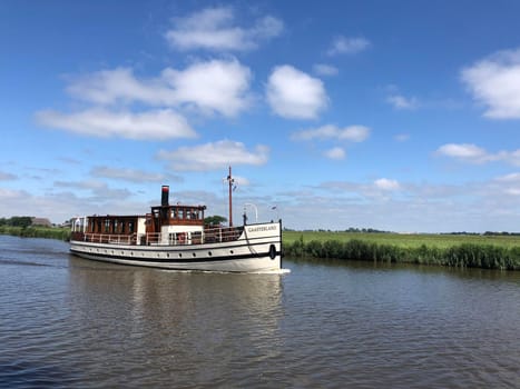 Classic tourism ship at the canal Dokkumer Ee in Friesland, The Netherlands
