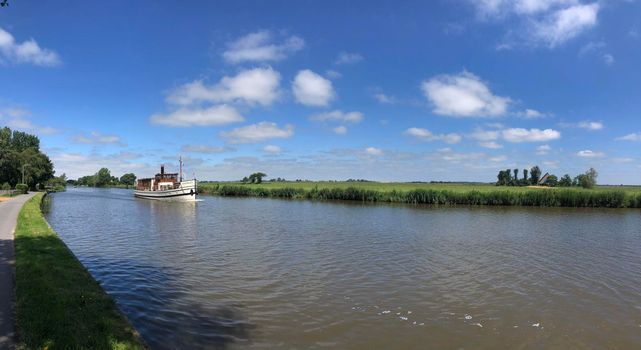 Classic tourism ship at the canal Dokkumer Ee in Friesland, The Netherlands