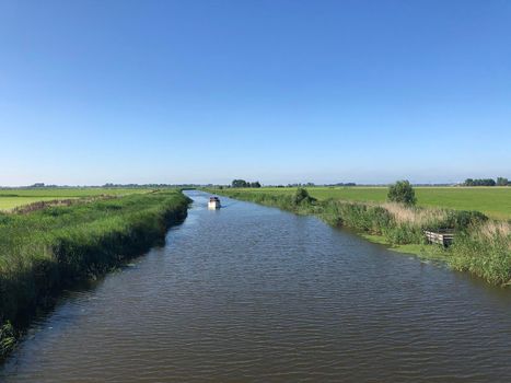 Boat on a canal in Friesland, The Netherlands