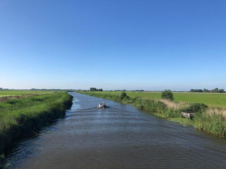 Boat on a canal in Friesland, The Netherlands