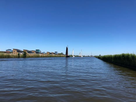 Sailing on a canal near Heeg in Friesland The Netherlands