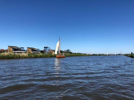 Sailing on a canal near Heeg in Friesland The Netherlands