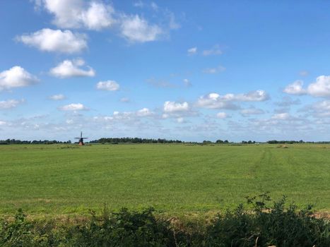 Dutch landscape with a windmill in Friesland The Netherlands