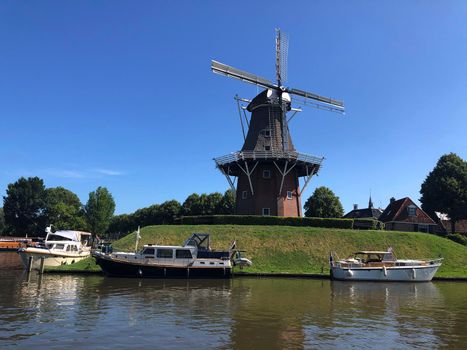 Windmill next to a canal in Dokkum, Friesland The Netherlands