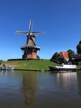 Windmill next to a canal in Dokkum, Friesland The Netherlands