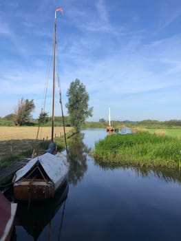 Sailboat in a canal around Langelille, Friesland The Netherlands