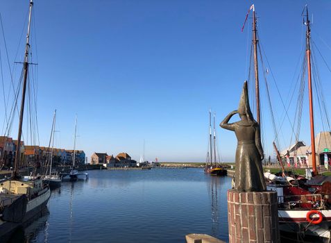 Lady of Stavoren statue in the harbor of Stavoren, Friesland The Netherlands
