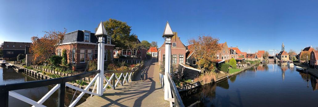 Panorama from a bridge over a canal in Hindeloopen during autumn in Friesland, The Netherlands