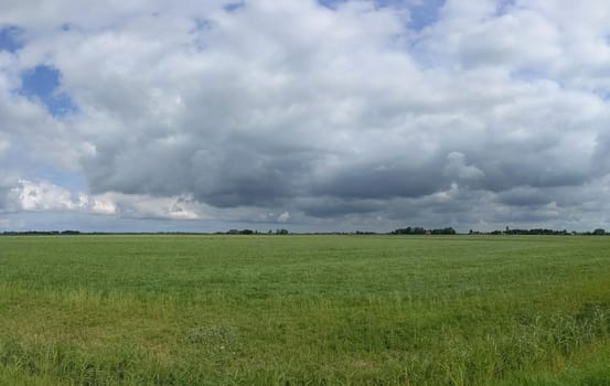 Cloudy Frisian panoramic landscape in The Netherlands