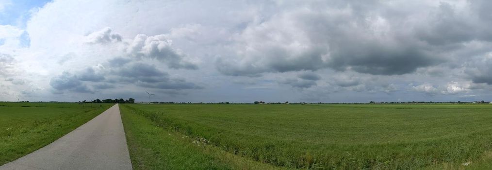 Cloudy Frisian panoramic landscape in The Netherlands