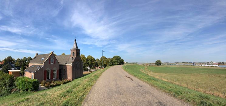 Small church behind the dyke around Millingen aan de Rijn in The Netherlands