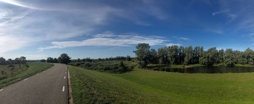 Road on a dyke around Ooij in Gelderland The Netherlands 