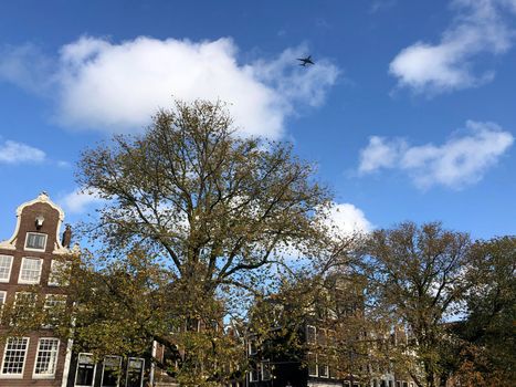 Airplane flying over the old town of Amsterdam, The Netherlands

