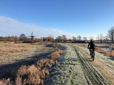 Cycling through winter landscape around Wolvega in The Netherlands