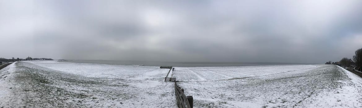 Panorama from a dike with snow in Hindeloopen The Netherlands
