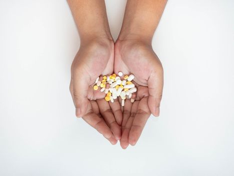 Colorful pills on hand On a white background