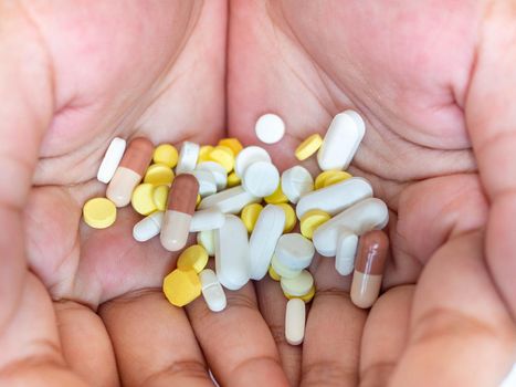 Colorful pills on hand On a white background