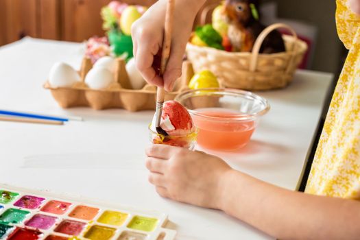 Cropped shot of adorable little girl painting egg for Easter.